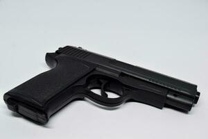 Close up black handgun isolated on White Background. criminal concept photo