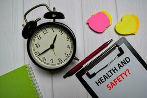 Health and Safety write on a paperwork isolated on wooden table. photo