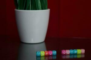 Input output text at colorful wooden block on red background. Desk office and education concept photo