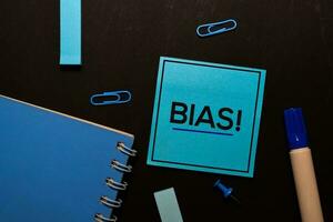 Bias write on sticky notes isolated on office desk photo