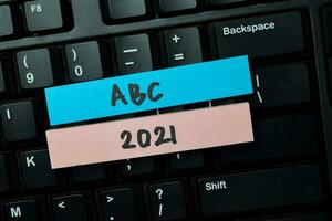 ABC 2021 write on sticky notes isolated on office desk. photo