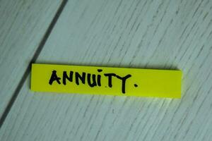 Annuity write on sticky notes isolated on office desk. Selective Focus on Annuity Text photo