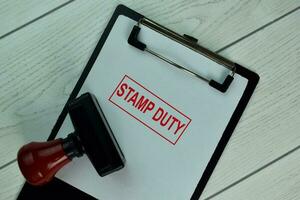 Red Handle Rubber Stamper and Stamp Duty text isolated on the table. photo