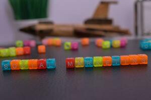 Social Marketing on wooden blocks. Cross processed image with business concept on White background photo