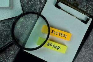 System Error write on sticky notes on the table. photo
