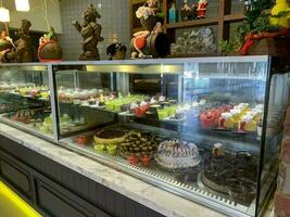 Sweet desserts behind the glass in cafe, sale. Studio Photo