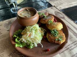 Potato pancakes with sauce, sauerkraut. Studio Photo