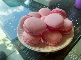 Homemade pink macaroons on plate. Studio Photo