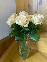 Bouquet of fresh roses in crystal vase. Studio Photo