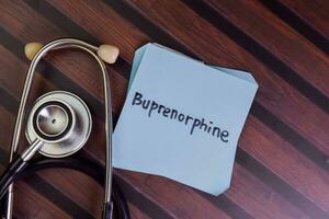 Buprenorphine write on sticky notes isolated on Wooden Table. photo