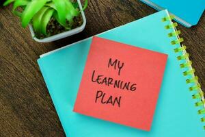 Concept of My Learning Plan write on sticky notes isolated on Wooden Table. photo