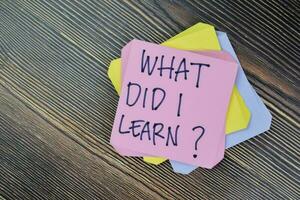 Concept of What Did I Learn Personal Development write on sticky notes isolated on Wooden Table. photo