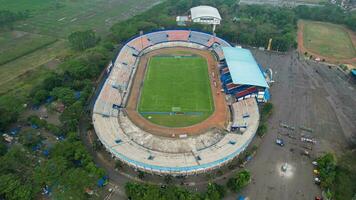 Aerial view of the Beautiful scenery of Kanjuruhan Stadium. with Malang cityscape background. Malang, Indonesia, August 26, 2022 photo