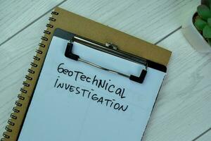Concept of Geotechnical Investigation write on paperwork isolated on Wooden Table. photo