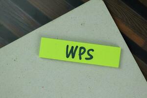 WPS write on sticky notes isolated on Wooden Table. photo