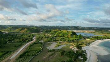 Aerial view of Tanjung Aan, Tropical island with sandy beach and turquoise ocean with waves. Lombok. Indonesia, Mach 22, 2022 photo