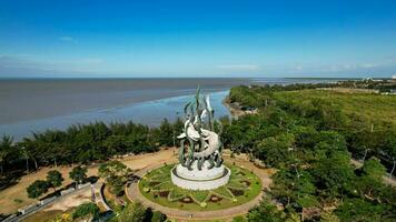 Aerial view of the A giant shark and crocodile statue as a symbol of the city of Surabaya. A landmark or monument as an icon of Surabaya city. East Java, Indonesia, August 28, 2022 photo