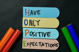 HOPE - Have Only Positive Expectations write on sticky notes isolated on office desk. photo