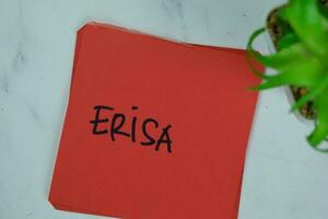 ERISA write on sticky notes isolated on Wooden Table. photo