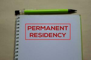 Permanent Residency write on a book isolated on Office Desk photo