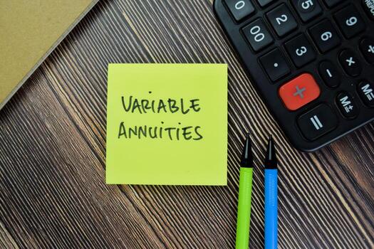 Concept of Variable Annuities write on sticky notes isolated on Wooden Table. photo