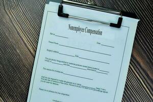 Concept of Nonemployee Compensation isolated on Wooden Table. photo