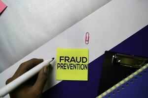 Fraud Prevention text on sticky notes with color office desk concept photo