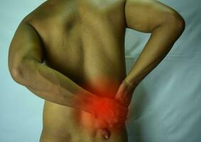 Feels pain in the small of the back. Back Pain, Physical Injury photo