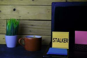 Stalker write on sticky note isolated white background photo