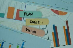 Plan Goals Vision write on sticky notes isolated on office desk. photo