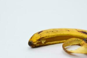 Close up yellow banana peel isolated on white background photo