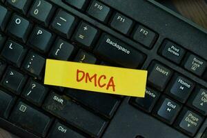 DMCA write on sticky notes isolated on Wooden Table. photo