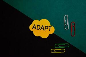 Adapt write on a sticky note isolated on Office Desk photo