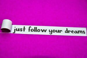 Just Follow your Dreams text, Inspiration, Motivation and business concept on purple torn paper photo