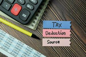 Tax Deduction Source write on sticky notes isolated on office desk. photo