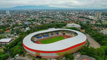 Aerial top down view of the Beautiful scenery of Manahan Solo Stadium. with cityscape background. Solo, Indonesia, December 6, 2021 photo
