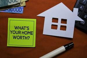 What's Your Home Worth on sticky Notes isolated on office desk. photo