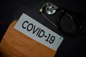 Covid-19 in brown envelope isolated on Office Desk. Healthcare or Medical Concept photo