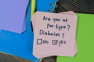 Concept of Are you at for type, Diabetes Yes write on sticky notes isolated on Wooden Table. photo