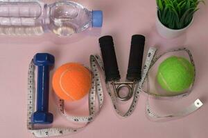 Love fitness concept with dumbbells and water bottle. Workout inspiration photo