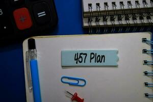 457 Plan write on sticky note isolated on Office Desk. photo