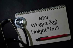 BMI - Weight and Height write on a book isolated on Office Desk. Healthcare or Medical Concept photo