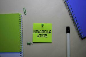 Extracurricular Activities text on sticky notes at office desk. photo