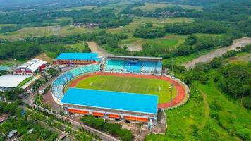 Aerial top down view of the Beautiful scenery of Moch. Soebroto Stadium. with Magelang cityscape background. Magelang, Indonesia, December 6, 2021 photo