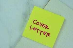 Concept of Cover Letter write on sticky notes isolated on Wooden Table. photo