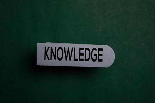 Knowledge write on a sticky note isolated on Office Desk photo