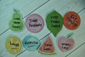 Healthy Lifestyle Concept and keywords write on sticky notes isolated on Wooden Table. photo