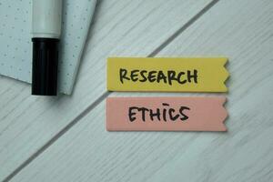 Research Ethics text on sticky notes isolated on office desk photo