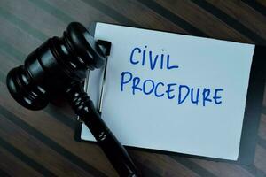 Concept of Civil Procedure write on a paperwork with gavel isolated on Wooden Table. photo