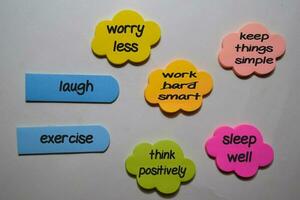 Think Positively concept write on sticky note with keyword isolated on Office Desk. photo